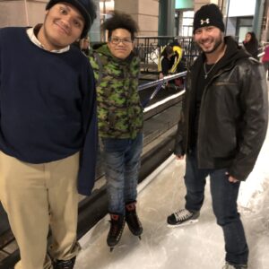 A group of boys standing, smiling at the camera.