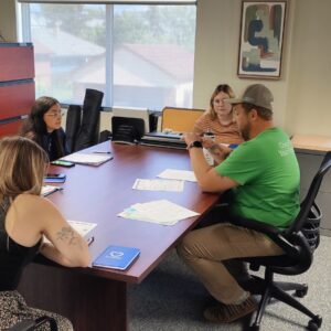 A group of Compeer interns sitting around a table.